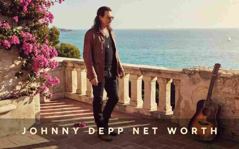 Johnny Depp standing on a sunlit Mediterranean villa balcony beside a vintage acoustic guitar, representing the immense Johnny Depp net worth and his quiet European lifestyle.